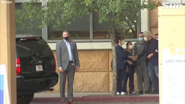 Bill Clinton unsteady as Hilary helps him out of hospital