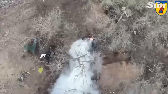 Ukrainian drone drops bomb on Russian soldiers hiding in foxholes