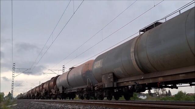 Bulmarket Freight Train heading to Kazichene Train Station in Bulgaria on a rainy cloudy day