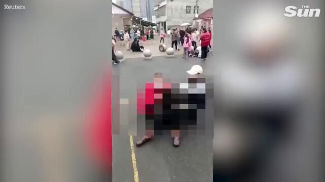 Driver ploughs SUV into primary school kids before he's dragged into street and beaten in China