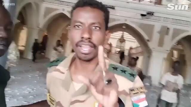 Sudanese soldiers wave guns as they seize Khartoum's presidential palace